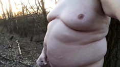 Chubby masturbates in the woods