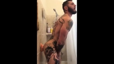 Tatted Hunk Fucks Dildo in Shower Until He Cums